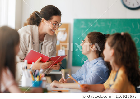 Happy kids and teacher at school Happy kids and teacher at school 116929653