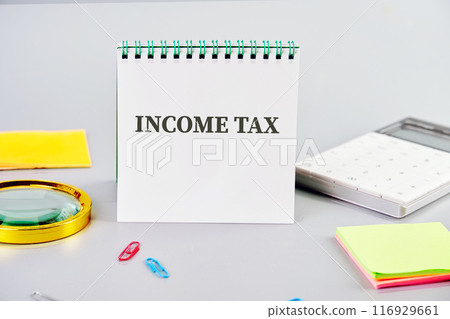 Business concept. The text INCOME TAX on a clean business notebook Business concept. The text INCOME TAX on a clean business notebook 116929661