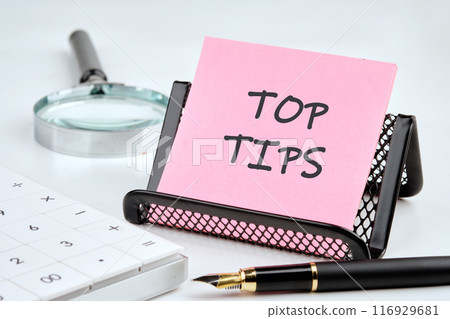 Business and Top tips concept, copy space. Top tips symbol on a pink sticker in a composition with business accessories 116929681