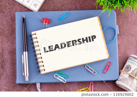LEADERSHIP word written in the notebook. View from above 116929802