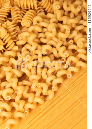 Food background of dry pasta close-up, top view Food background of dry pasta close-up, top view 116929941