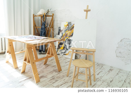 A Bright and Innovative Art Studio Featuring Beautiful Wooden Furniture along with Captivating Paintings 116930105
