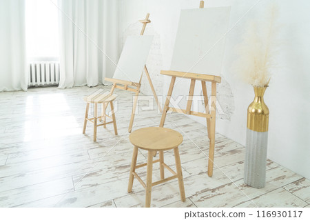 A Bright and Innovative Art Studio Featuring Beautiful Wooden Furniture along with Captivating Paintings 116930117