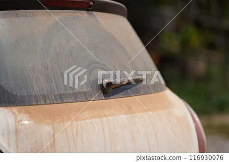 a lot of red brown dust on backside mirror car with one whisk of it. 116930976