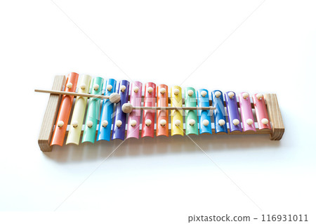 Two wooden sticks on colorful rainbow  xylophone instrument toy isolated on white table background. 116931011