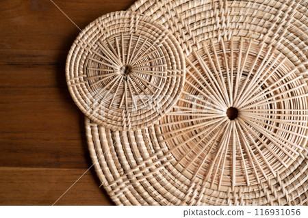 Close up to Round Circle woven straw mat Wicker pattern of local Thai handmade craft. Close up to Round Circle woven straw mat Wicker pattern of local Thai handmade craft. 116931056