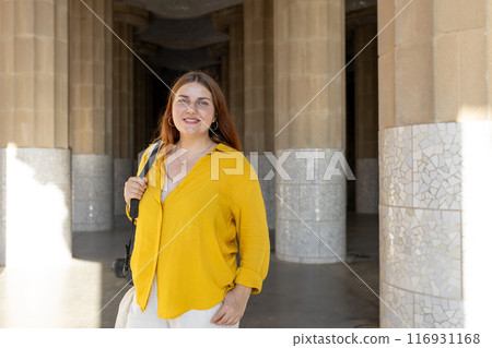 Beautiful female in Gaudi garden, Spain, Barcelona. Young traveling woman posing outdoors. Concept of travel, tourism and vacation in city. Hypostyle hall 116931168