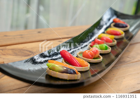 Luk Choop is the popular Thai Desserts in fruit shaped mung bean which are painted with food coloring then coated by jelly. 116931351