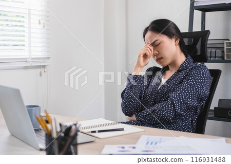 Businesswoman is thinking and is stressed about work. 116931488