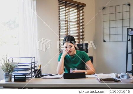 Businesswoman is thinking and is stressed about work. 116931646
