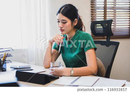 Businesswoman is thinking and is stressed about work. Businesswoman is thinking and is stressed about work. 116931657