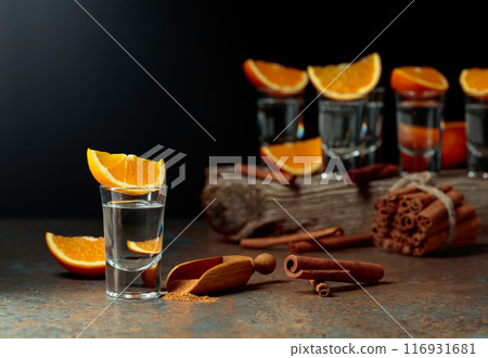 Tequila shots with orange and cinnamon. 116931681