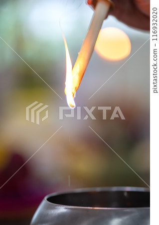 A drops of melting wax upside down with blur circle bokeh in religious event 116932020