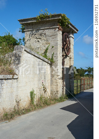 The entrance door and wheel of the Fortress at  Aix island in atlantic ocean The entrance door and wheel of the Fortress at  Aix island in atlantic ocean 116932731