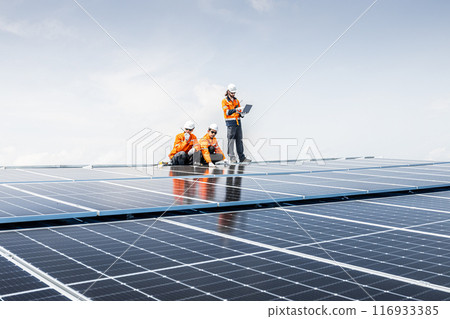 Group of Professional Engineer Service Solar Panel. Worker Team Maintenance Cleaning Replacing Solar Panel. Solar photovoltaic panel system in Industry roof. Saving Energy with Clean Power. Group of Professional Engineer Service Solar Panel. Worker Team Maintenance Cleaning Replacing Solar Panel. Solar photovoltaic panel system in Industry roof. Saving Energy with Clean Power. 116933385