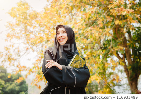 Muslim student in university wearing black niqab. Arab black chador lady. 116933489