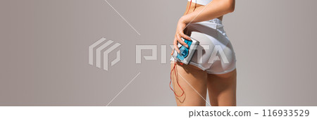 Cropped image of female body, buttocks, model posing in underwear with retro music players in headphones 116933529