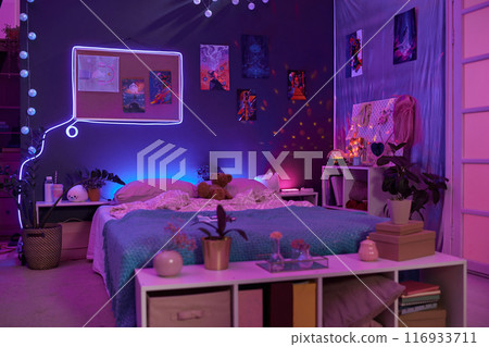 Background image of girls room interior with pink and purple neon lights over comfortable bed and fluorescent art copy space Background image of girls room interior with pink and purple neon lights over comfortable bed and fluorescent art copy space 116933711