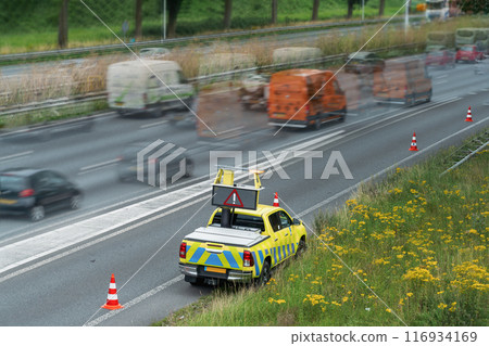 Police car directing traffic on highway. Selective focus 116934169