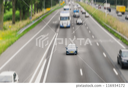 Blue car driving on the highway. Selective focus 116934172