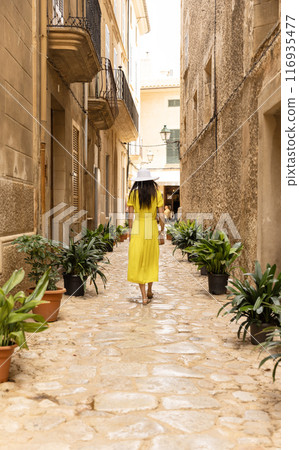 Young girl walking on the street in old village, Mallorca 116935477