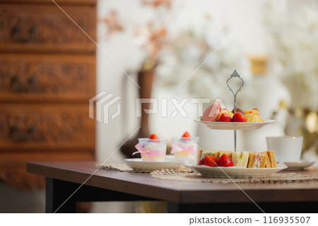 A woman eating sweets at a cafe A woman eating sweets at a cafe 116935507