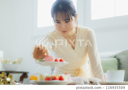 A woman eating sweets at a cafe A woman eating sweets at a cafe 116935509
