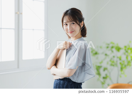 Young woman using a personal computer Young woman using a personal computer 116935597