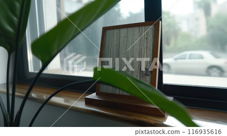 Decorative Wooden Frame With Artistic Texture on Window Sill Surrounded by Greenery 116935616