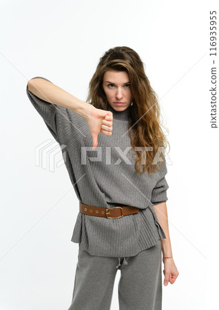 Young attractive woman showing thumb down on white background. 116935955
