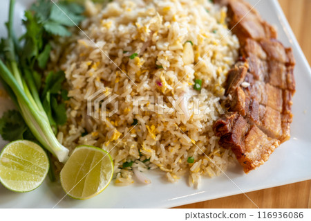 Fried rice with crispy pork served on plate 116936086