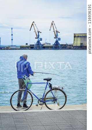 Senior man fishing in the port Senior man fishing in the port 116936191