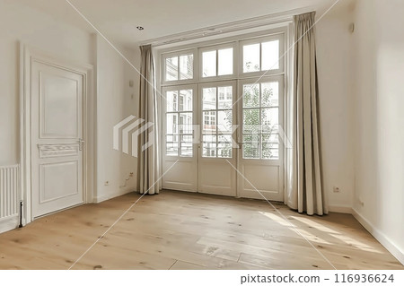 Interior of empty living room with large bright window and curtains by closed door in modern apartment with white walls and hardwood floor 116936624