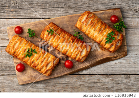 Golden Puff pastry stuffed with sausage and cheese 116936948