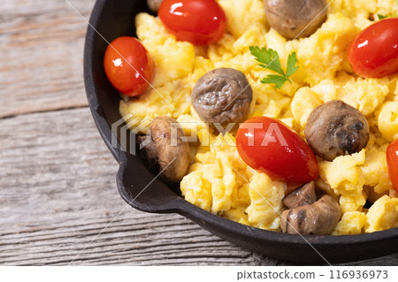 Homemade scrambled eggs with mushrooms and cherry tomatoes Homemade scrambled eggs with mushrooms and cherry tomatoes 116936973