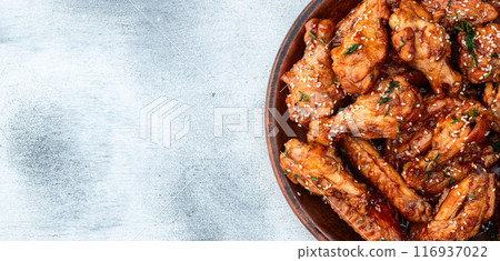 Caramelized in sause chicken wings  . Bar-b-q food background photo 116937022