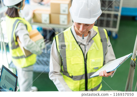 Male staff member managing logistics Male staff member managing logistics 116937050