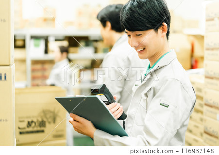A young man managing inventory in the backyard 116937148