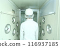 A worker taking an air shower 116937185