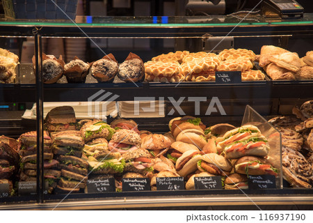 Various breads displayed in a showcase at a bakery shop in Munich station, Germany Various breads displayed in a showcase at a bakery shop in Munich station, Germany 116937190