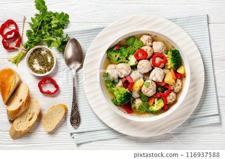 chicken meatball soup with vegetables in a bowl 116937588