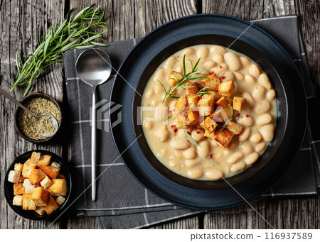 rosemary garlic creamy white bean soup in bowl rosemary garlic creamy white bean soup in bowl 116937589
