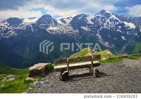 A bench with a view of the mountains in Austria. Landscape with nature in the Alps. A great place for sports, recreation and outdoor activity holidays. Grossglockner - the highest mountain in Austria 116938281