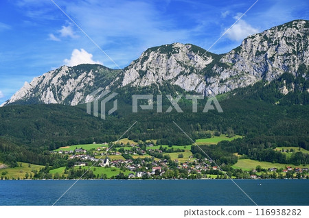 Attersee - a beautiful blue lake in Austria. Surrounded by mountains and green forests. Regions with nature in the Alps. A great place for sports, recreation and outdoor activity holidays. 116938282