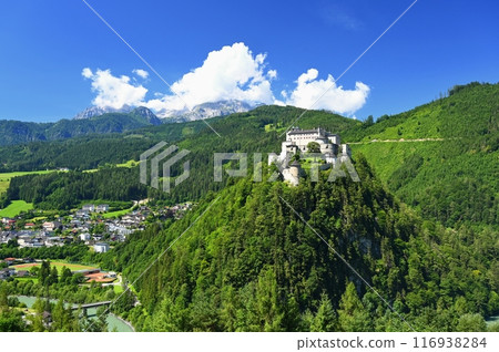 A landscape with nature and a beautiful old castle. Hohenwerfen medieval castle towering over the Austrian town of Werfen. 116938284