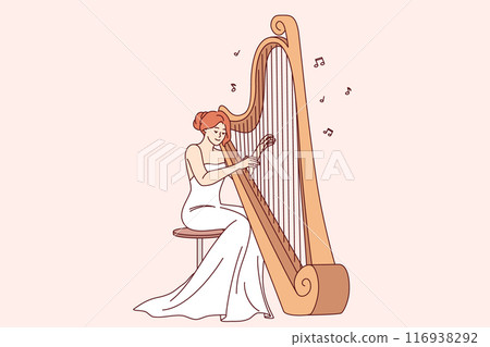 Woman plays large harp, performing at symphony concert or classical music festival 116938292