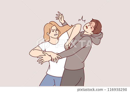 Woman demonstrates self-defense technique by striking man in face pretending to be maniac or robber 116938298
