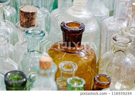 Big group of small empty glass bottles, aged and dusty Big group of small empty glass bottles, aged and dusty 116939284