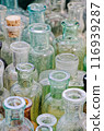 Big group of small empty glass bottles, aged and dusty 116939287