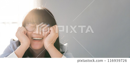 Banner Artwork Panorama close up to Asian HAPPY GLASSES girl face in  the bedroom with sunlight from the window behind her. 116939726